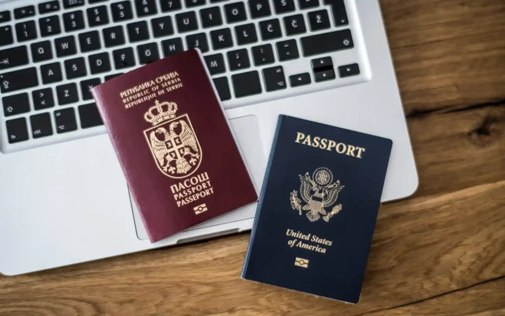 Serbian and US passports on a laptop